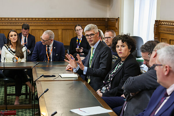 Al speaking in a debate.