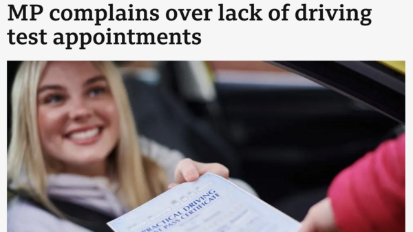 Picture of a women receiving her driving test certificate. 