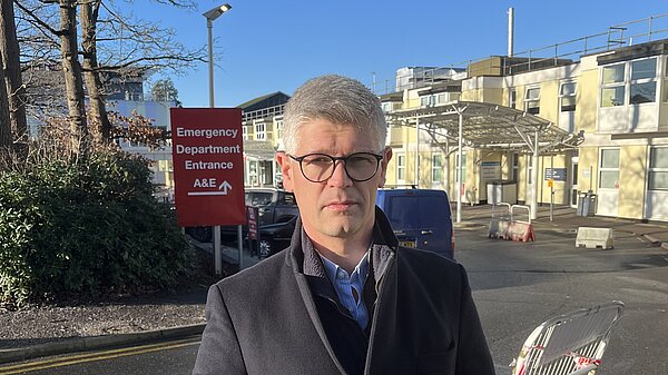 MP standing outside local hospital 